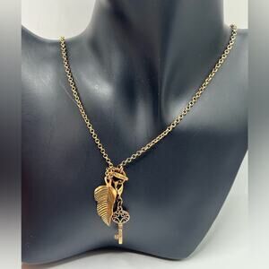 Pilgrim gold tone necklace with key and feather charms